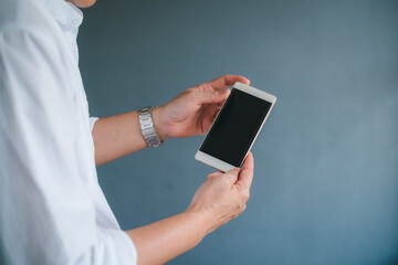 Business man using smartphone on blur background.