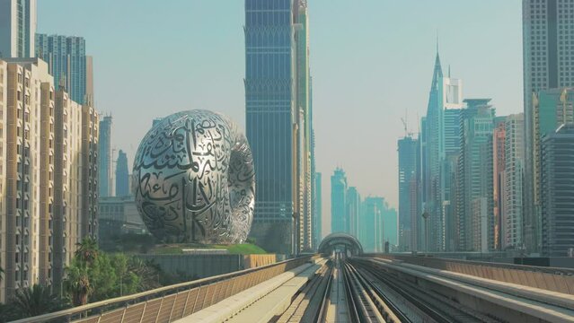 Dubai, UAE, United Arab Emirates. Monorail POV Subway train rides among skyscrapers, Museum of the Future in Dubai.