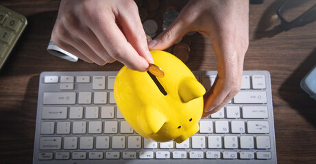 Male hand putting coin to piggy bank. Saving