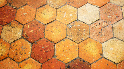 Old terracotta tile floor. Honeycomb pattern. 
