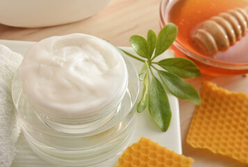 Detail of cream with honey extracts and container with honey