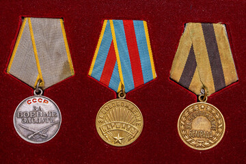 Soviet military medals of World War II on red background