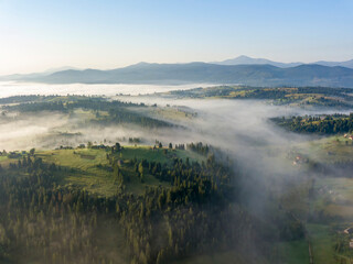 Morning fog in the Ukrainian Carpathians. Aerial drone view.