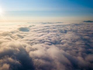 High flight above the clouds. Aerial drone view.
