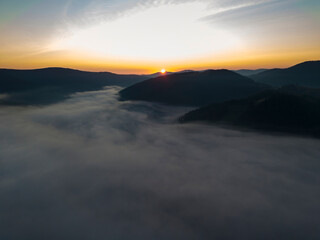 Obraz premium Sunrise over the fog in the Ukrainian Carpathians. Aerial drone view.