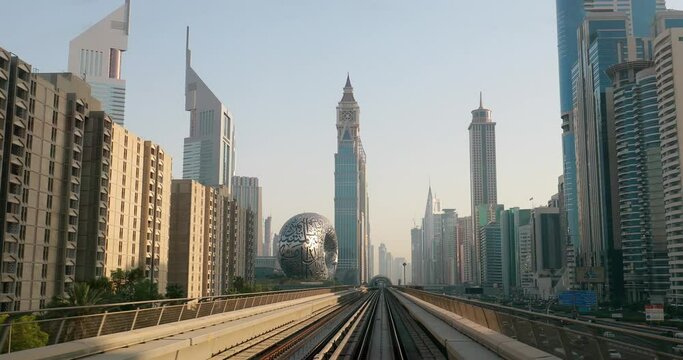 Dubai, UAE, United Arab Emirates. Monorail POV Subway train rides among skyscrapers, Museum of the Future in Dubai. Dubai, UAE, United Arab Emirates. Monorail POV Subway train rides among skyscrapers