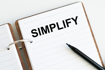 simplify the inscription on the notebook on the table, business concept