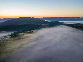 Morning fog in the Ukrainian Carpathians. Aerial drone view.