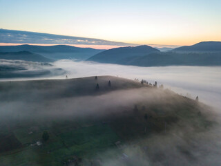 Morning fog in the Ukrainian Carpathians. Aerial drone view.