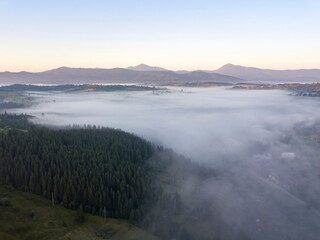 Sunrise over the fog in the Ukrainian Carpathians. Aerial drone view.