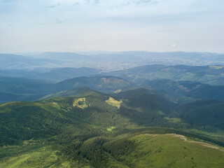 High mountains of the Ukrainian Carpathians in cloudy weather. Aerial drone view.
