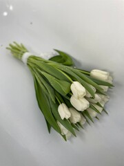 bouquet of white tulips on a wooden table