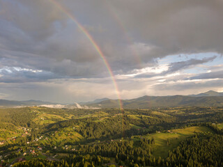 Rainbow in the mountains of the Ukrainian Carpathians. Aerial drone view.