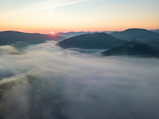 Obraz premium Sunrise over the fog in the Ukrainian Carpathians. Aerial drone view.