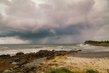 Fototapeta na wymiar Pebbly Beach at Forster in NSW Australia with storm clouds in distance