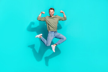 Fototapeta na wymiar Full length profile photo of confident strong sportsman jump show biceps wear pullover isolated blue color background