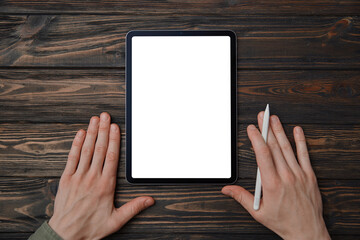 man with a stylus starting work on a Tablet pc .