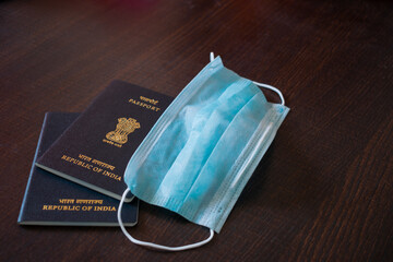  Close up picture of Indian passports along with boarding passes and mask. Mask free travel, visa,...