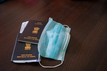 Close up picture of Indian passports along with boarding passes and mask. Mask free travel, visa,...