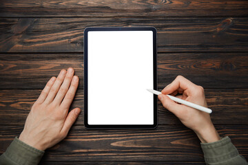 man with a stylus starting work on a Tablet pc .