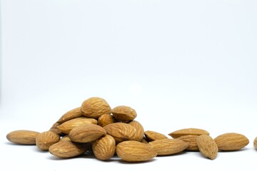 A picture of a heap of almonds with white background.