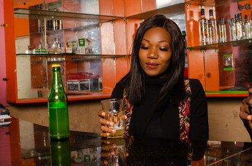 lady in the pub, bar drink a bottle of beer