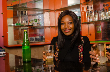 lady smiling as she holds a bottle of beer on her hand