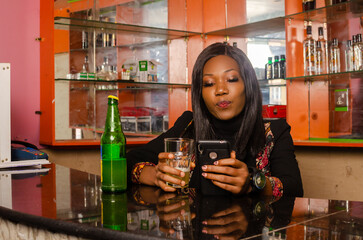 beautiful Alcoholic lady using her cellphone