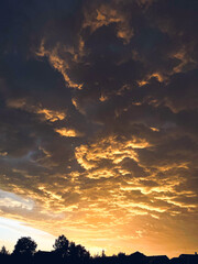 incredible color of clouds. Sunset over the village.