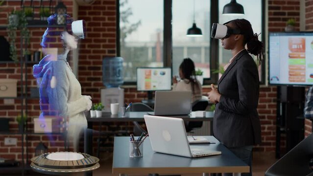 Woman attending business meeting with coworker on hologram, using virtual reality metaverse and VR headset. Virtual reality advanced technology online video conference with holographic high tech image