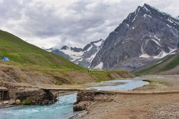 A beautiful scenic view with a river, mountains, meadow and snow in Panchtarni, Amarnath ji, Kashmir, India