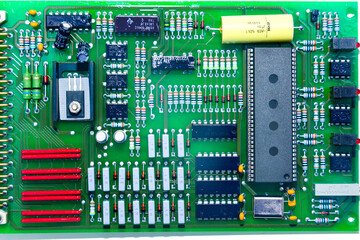 Computer board with soldered chips and semiconductors, close-up.
