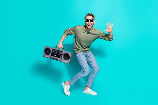 Full length photo of crazy positive cheerful clubber man dance hold tape radio wear pullover isolated blue color background