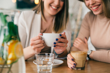 women are having coffee break in cafeteria