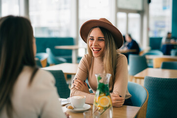 women are having coffee break in cafeteria