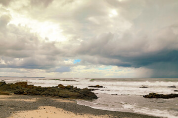 Pebbly Beach at Forster in NSW Australia with storm clouds in distance