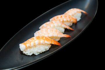Top view of Shrimp sushi on black plate, focus selective