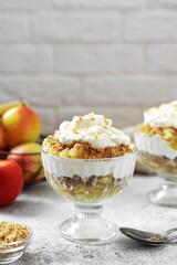 Apple trifle in a glass bowl on a light culinary background. Traditional Scandinavian aebletrifli on the kitchen table