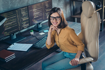 Portrait of attractive cheerful skilled girl agent broker director debugging web project at...