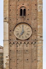 Fototapeta na wymiar The clock in the bell tower of the cathedral in Parma, Italy, strikes seven o'clock