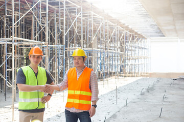 Naklejka premium Three engineers working in a construction site