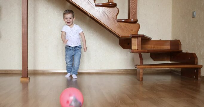 boy play football in cozy room at home