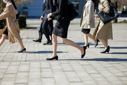 スーツで歩く女性の顔なし画像