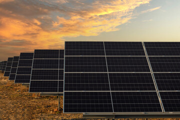 Pannel solar with full power on farm. Photovoltaic power generation, sunset  Row