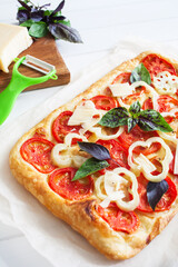 Colorful rectangle pizza bacon white wooden background selective focus.