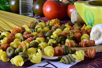 Healthy foods, colored pasta, tomatoes and more ingredients, which provide well-being to our body.
