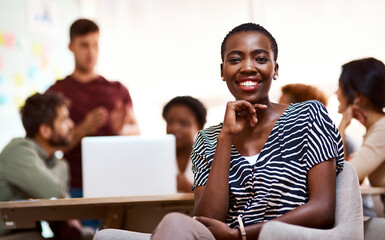 My career suits my creative personality. Portrait of a confident young businesswoman sitting in an office.