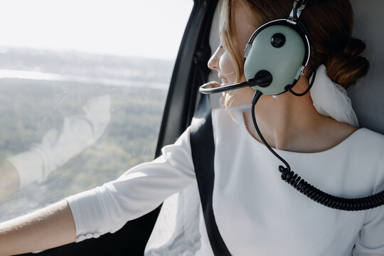 The bride is sitting in a helicopter