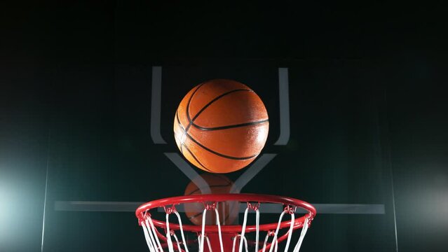Super slow motion of basketball ball hitting the basket. Filmed on high speed cinema camera, 1000fps. Camera in motion.