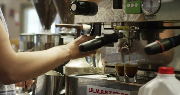 Woman making coffee on espresso machine 